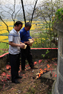 Paying respects to YeYe ( Baba's dad ) - YanGe (DaJiu's son) and ShuShu ( Daisy's dad's younger brother ).  

YeYe's grave is in this spot because it is where he died of starvation in the sixtys   He was walking to another nearby grave and just fell down here and died, and his grave is very simple because times were poor back then.