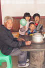 YiFu, He Jia Yi, YiMa, and He Jia Fu at thier kitchen table / coal stove - we stayed with them this year in their new house and they were great hosts