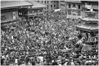 Bhaktapur / Prakas Dhaubhadel, proprietor of the Hotel Heritage,  was kind to invite us to his house on Taumadhi Square to watch the Chariot of Bhairab being pulled during the first day of Bisket Jatra at Bhaktapur heralding the start of the Nepali New Year.    Bhairav, the other god on the Chariot is the fierce manifestation of Shiva associated with annihilation: a well respected rude god. 
The tug of war teams for the chariot carrying two gods from the temple in the square consists of the upper side of the town v.s. the lower side of the town ( population 80,000 ).   The result is always the demise of the chariot  followed by a brick fight between the two teams to settle the winner.   The teams join each other from time to time to attack the police, who are abundant and armed, and whenever the police retreat, the brick fight between upper and lower sides resumes.   
It is an exciting injurious celebration and teams of red cross doctors arrive early.