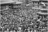 Bhaktapur / Prakas Dhaubhadel, proprietor of the Hotel Heritage,  was kind to invite us to his house on Taumadhi Square to watch the Chariot of Bhairab being pulled during the first day of Bisket Jatra at Bhaktapur heralding the start of the Nepali New Year.    Bhairav, the other god on the Chariot is the fierce manifestation of Shiva associated with annihilation: a well respected rude god. 
The tug of war teams for the chariot carrying two gods from the temple in the square consists of the upper side of the town v.s. the lower side of the town ( population 80,000 ).   The result is always the demise of the chariot  followed by a brick fight between the two teams to settle the winner.   The teams join each other from time to time to attack the police, who are abundant and armed, and whenever the police retreat, the brick fight between upper and lower sides resumes.   
It is an exciting injurious celebration and teams of red cross doctors arrive early.