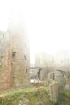 Wales —  not the fish / A castle in a Pembrokshire hailing gale. The wind blew the door off the ticket office and they gave us free admission.