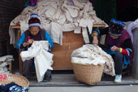 Stiching cloth: Tye-dyeing in China predates hippies 1000 years.   While the Miao minorities in GuiZhou use wax to form patterns; the Bai minority workers at ZhouCheng use stitching to knot the cloth into beautiful patterns before soaking the cloth in wooden vats of natural indigo dye.    The women we met doing this work were well into their seventies, had great eye sight, and have been stitching cloth for dying for over 50 years.