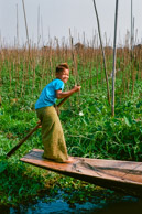 Kid paddling through floating lotus farms at  Maing Thauk.     (35mm Kodak Ektar 100)