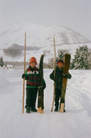Kids on their way to school.   Skis are made of pine wood with horse skins on the bottom enabling them to slide down hill and grip up hill.  The earliest evidence of skiing on earth are 10,000 year old wall paintings of skiing from here in the ALeTai mountains.  (M2 Portra 800)